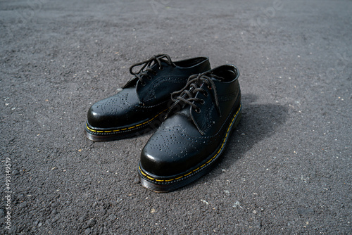 Detail view of the classic brogue wingtip men's black genuine leather shoes with rubber sole