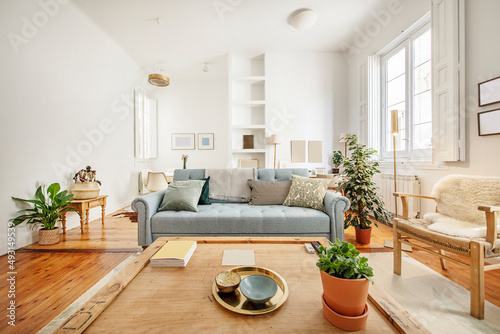 Fotografie living room with white walls and vintage wooden furniture with plants and decora