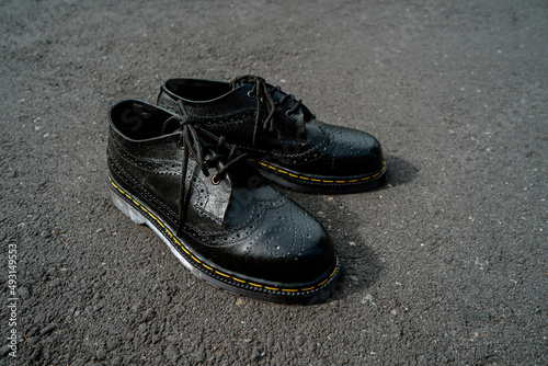 Detail view of the classic brogue wingtip men's black genuine leather shoes with rubber sole
