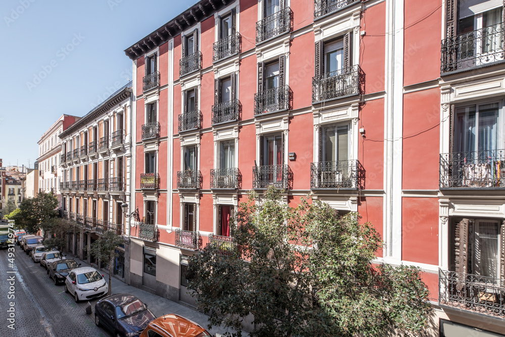 facade of urban residential houses of vintage buildings in a central street of Madrid