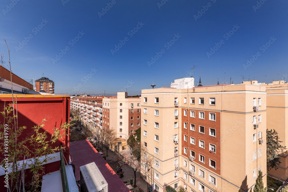 facades of residential houses and views of a street in the city of Madrid on a sunny spring day