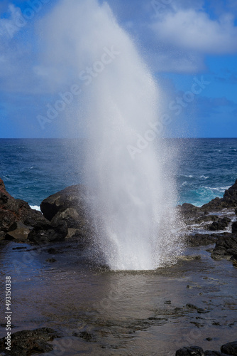 Marine geyser of Nakelele Blowhole on West Maui in the Hawaiian Islands, USA - Spout of water on volcanic rock created by the waves of the Pacific Ocean in the Poelua Bay