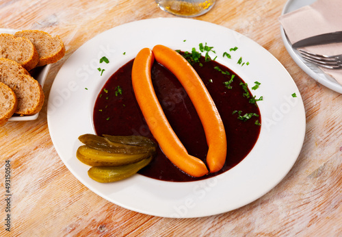 Fresh portion of Viennese goulash with two sausages served on table.