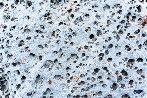 texture of porous stones on the beach, nature, natural phenomena, brown gray stones photo
