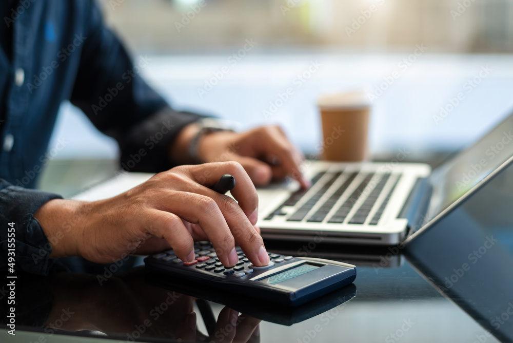 businesswoman or accountant hand holding pen working  to calculate