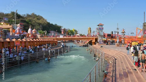 Haridwar, Uttarakhand, India - 10th April 2021 : Hindu devotees bathing in Holy river Ganges, on the occassion of Kumbh Mela. Ritual is called shahi snan, shaahi snan or Kumbh snan. 4k video. photo