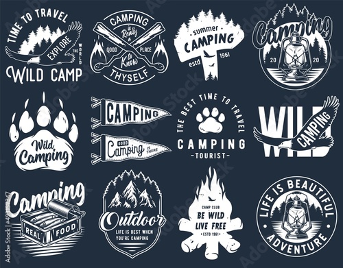 Set of monochrome camping and travel emblems, including campfire, outdoor lantern, forest wild life and eagle
