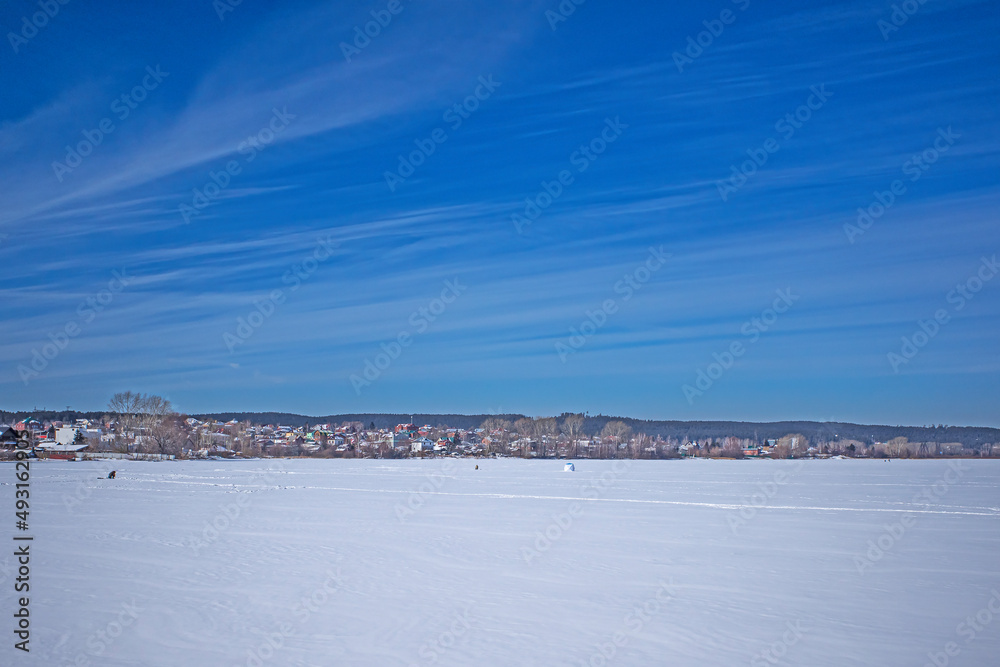 Winter landscape of the city pond on a sunny day