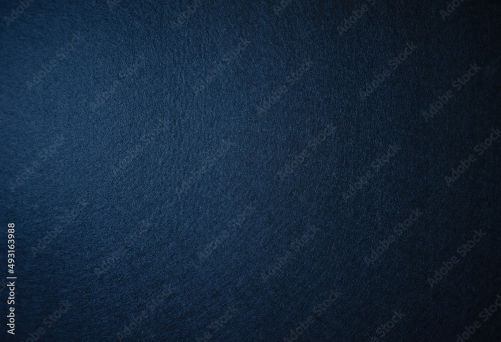 Photo of the texture of felt fabric in dark blue.Pure blue background for the inscription. Soft dark background. Fabric backing. Photo of the texture of felt fabric in dark blue.Pure blue background for the inscription. Soft dark background. Fabric backing.