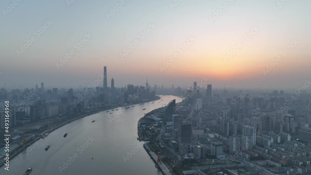 Drone aerial view of Sunset in Huangpu River downtown Shanghai China. Travel, business and cityscape concept b-roll footage. The beautiful sunset in the dusk with the background of Lujiazui landmarks Drone aerial view of Sunset in Huangpu River downtown Shanghai China. Travel, business and cityscape concept b-roll footage. The beautiful sunset in the dusk with the background of Lujiazui landmarks