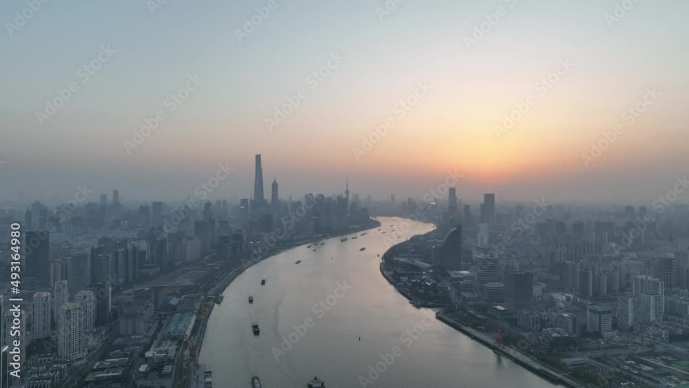 Drone aerial view of Sunset in Huangpu River downtown Shanghai China. Travel, business and cityscape concept b-roll footage. The beautiful sunset in the dusk with the background of Lujiazui landmarks Drone aerial view of Sunset in Huangpu River downtown Shanghai China. Travel, business and cityscape concept b-roll footage. The beautiful sunset in the dusk with the background of Lujiazui landmarks