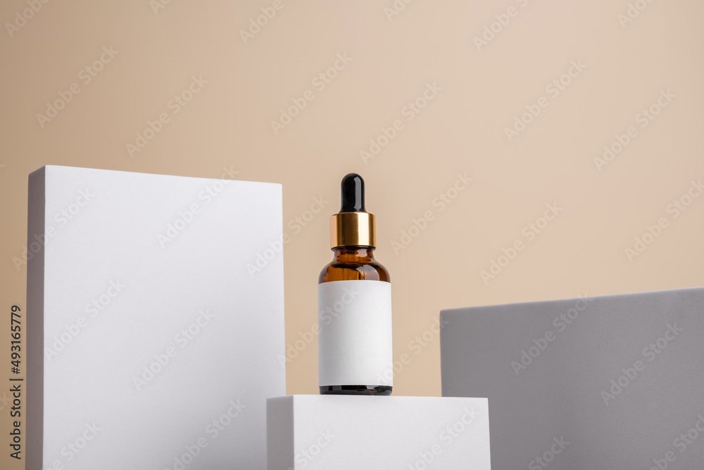 Geometric light composition with glass brown serum with skin care dropper with logo mockup. Health and beauty concept Geometric light composition with glass brown serum with skin care dropper with logo mockup. Health and beauty concept