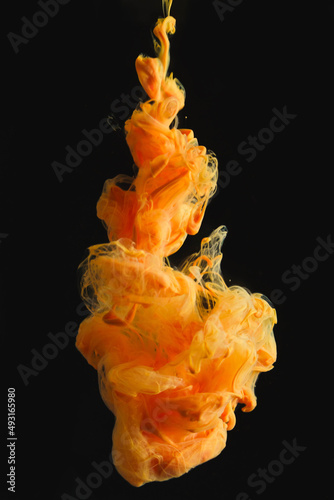 Orange ink drop in clear water and black background. abstract image for background or color reference.