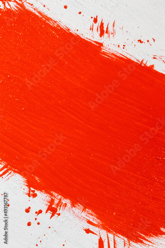 thick red acrylic paint applied in an uneven patch on a flat surface