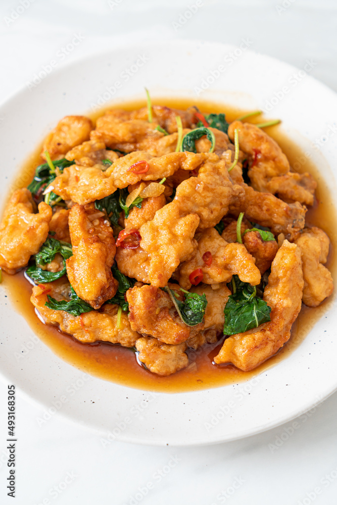 stir-fried fried fish with basil and chili in thai style stir-fried fried fish with basil and chili in thai style