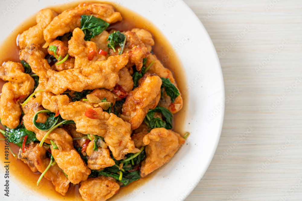 stir-fried fried fish with basil and chili in thai style stir-fried fried fish with basil and chili in thai style