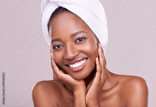 To be beautiful is to be yourself. An isolated studio portrait of a beautiful young woman wearing a towel on her head.