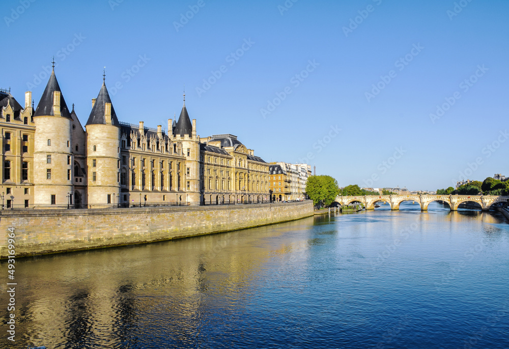 Beautiful panoramic view from the Seine River to the bridge and the city landscape on a sunny summer day. Paris, France Beautiful panoramic view from the Seine River to the bridge and the city landscape on a sunny summer day. Paris, France