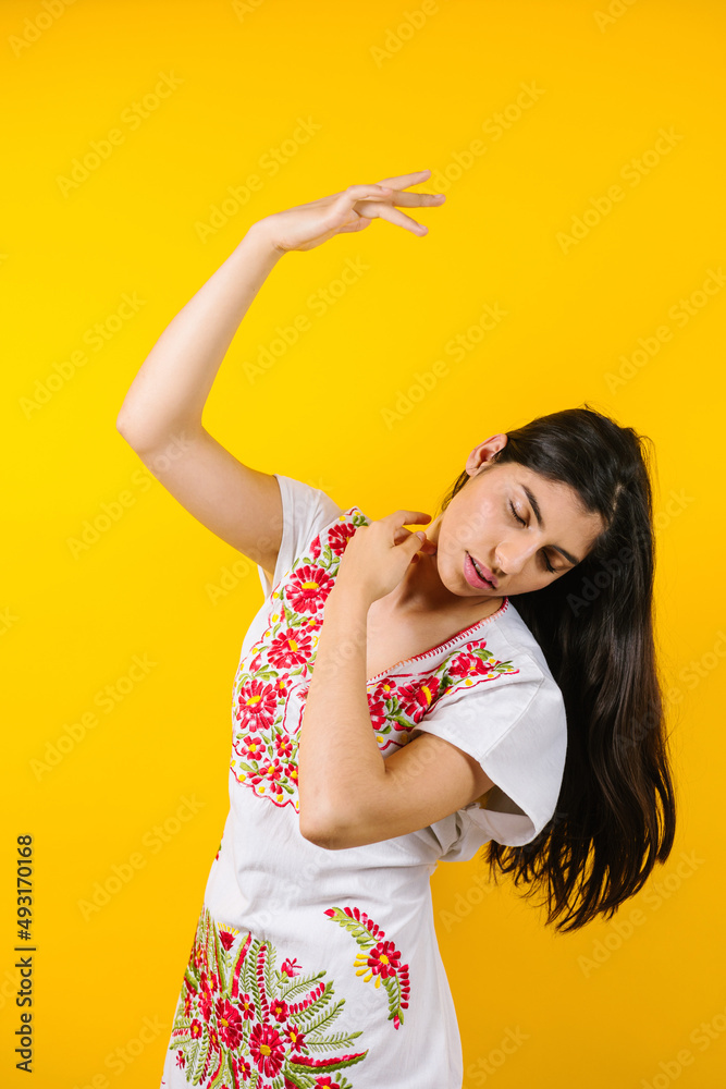 portrait of young latin woman with mexican dress and copy space on yellow background in Latin America
portrait of young latin woman with mexican dress and copy space on yellow background in Latin America