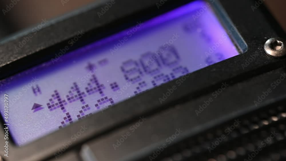 close-up of a handheld HAM radio. Color lights up the screen on this slider shot close-up of a handheld HAM radio. Color lights up the screen on this slider shot