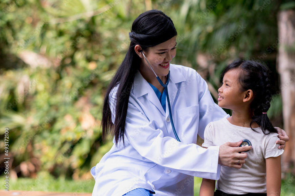 doctor woman with little girl in park. doctor woman with little girl in park.