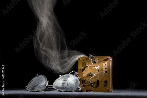 Still life with old dusty glasses and clockwork