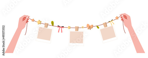 Two hands grabbing a rope decorated with blank polaroid pictures and cute ornament template flat vector illustration. Set of pictures in one hand reminds a lot of memories isolated background.