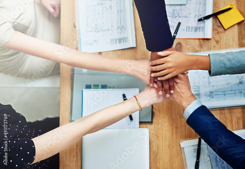 Each individual an integral part of the whole. Cropped shot of a group of unidentifiable businesspeople putting their hands on top of each other during a meeting.