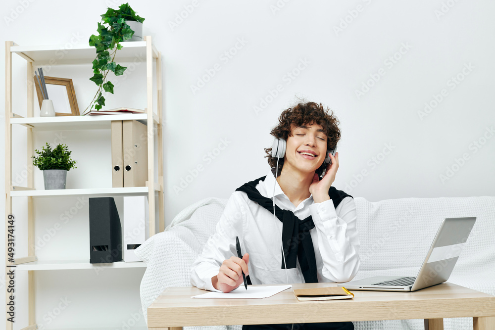 teenager in headphones with a book at home Lifestyle technology teenager in headphones with a book at home Lifestyle technology