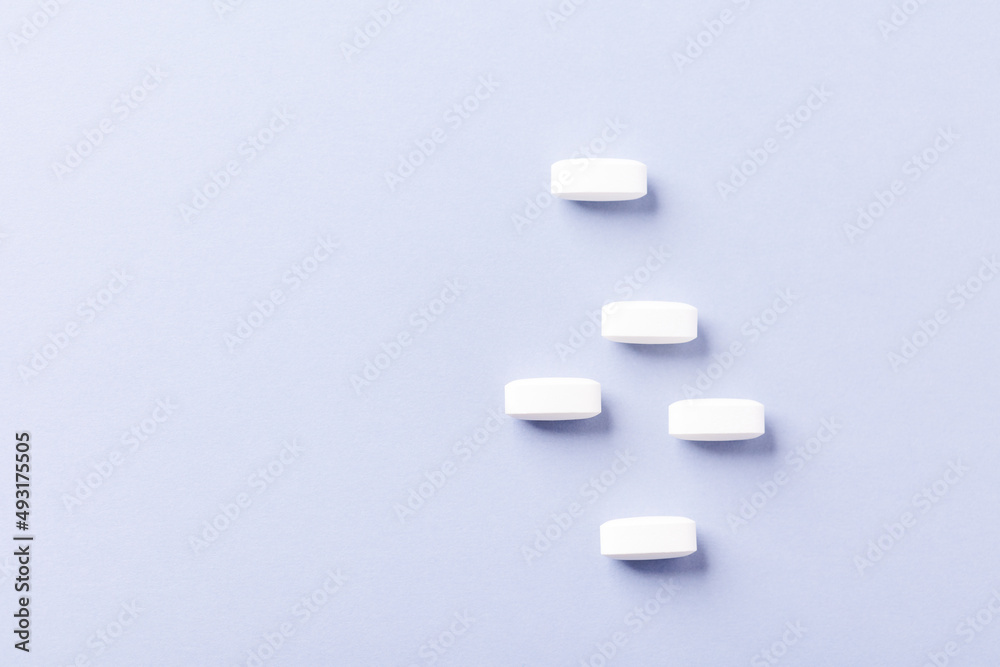 Lysine tablets. Concept for a healthy dietary supplementation. Nervous System Support. Soft focus. Bright background. Top view. Copy space. Lysine tablets. Concept for a healthy dietary supplementation. Nervous System Support. Soft focus. Bright background. Top view. Copy space.