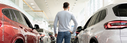 choosing a new car for a family man in a car dealership