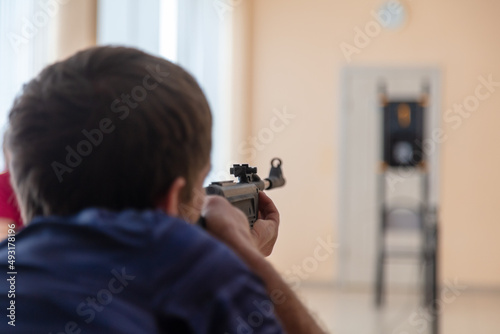A man shoots from a gun at a target.