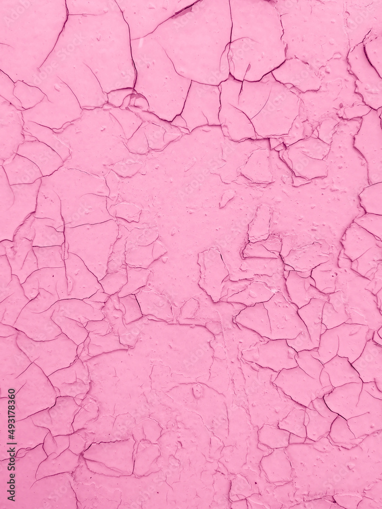 Cracked pink paint on the wall as an abstract background.