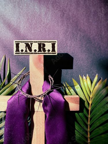 INRI text written on top of wooden cross in purple vintage background. Lent Season,Holy Week and Good Friday concepts. Stock photo.
 photo