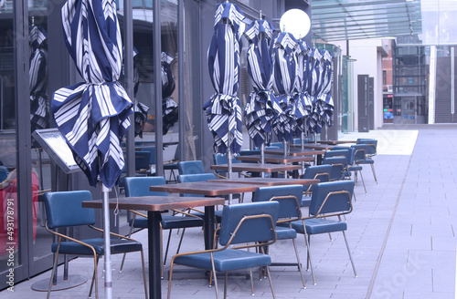 Photography A restaurants's blue outdoor seating area early in the morning