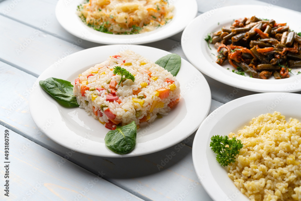 Variety of garnishes like cooked rice, bulgur, stewed cabbage and green beans Variety of garnishes like cooked rice, bulgur, stewed cabbage and green beans