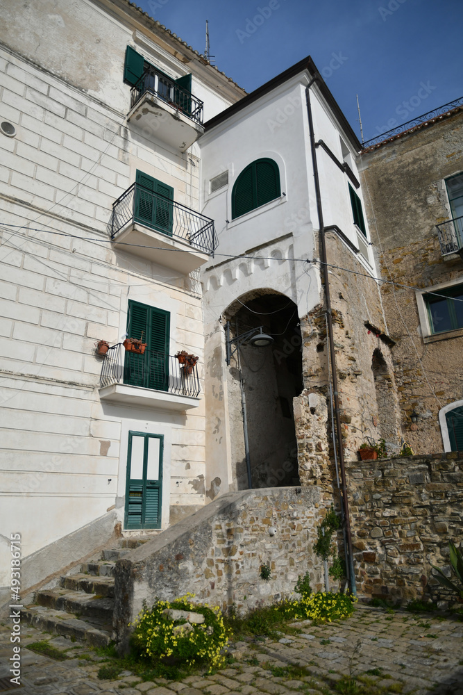 A narrow street among the old stone houses of Castellabate, town in Salerno province, Italy.	