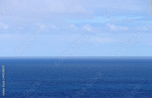 Wallpaper Mural Flat blue ocean, straight horizon, blue sky and soft clouds. Sydney Australia Torontodigital.ca