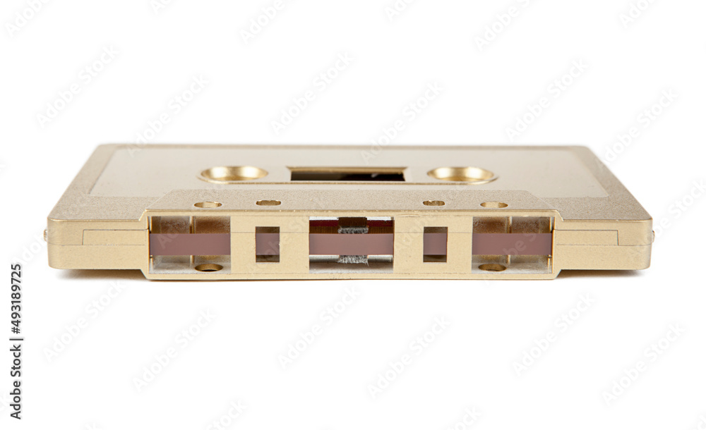 A golden cassette tape on the white background A golden cassette tape on the white background
