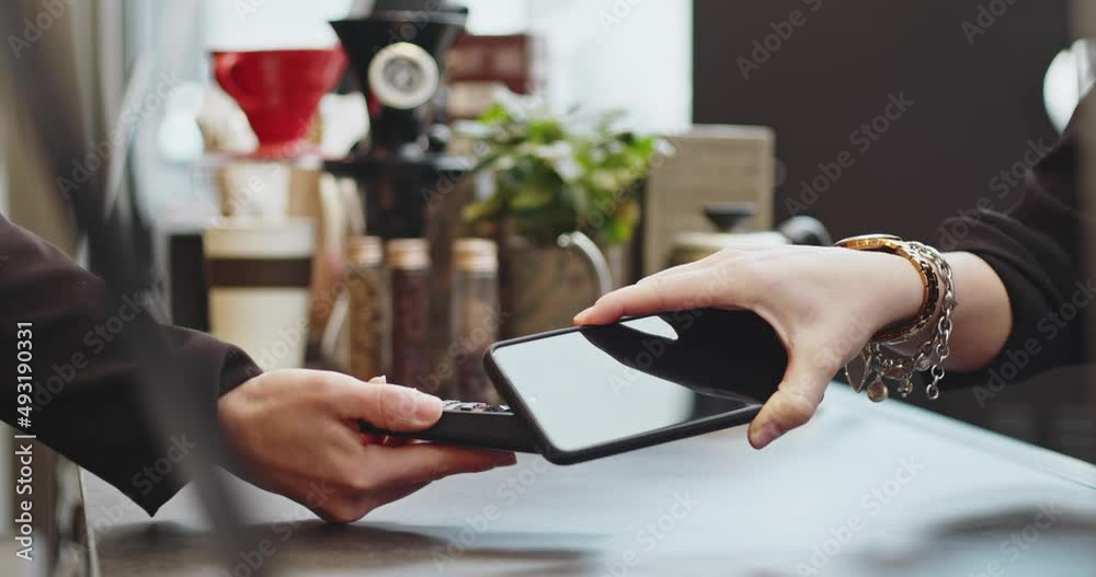 Close-up woman paying using NFC technology with phone contactless payment with student girl, business woman.Pay by phone on electronic payment machine or card reader. E-money at cashless wallet