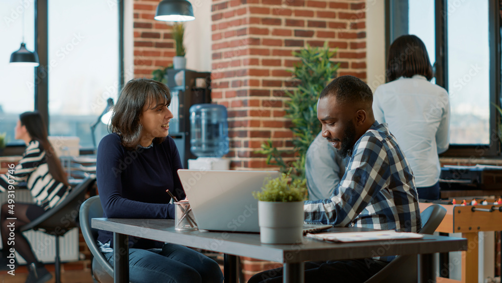 Male employee greeting female candidate at job interview to discuss about hiring and business career. HR recruiter interviewing woman in office, attending job offer and recruitment meeting.