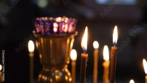 Burning church candles in the Orthodox cathedral. The concept of Christianity, rituals, faiths, religions, prayers, funeral services