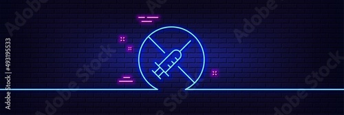 Neon light glow effect. No vaccine line icon. Stop Vaccination sign. Syringe jab symbol. 3d line neon glow icon. Brick wall banner. No vaccine outline. Vector