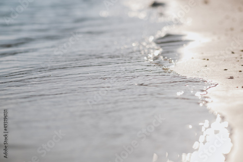 Closeup image of the sea and white sand beach