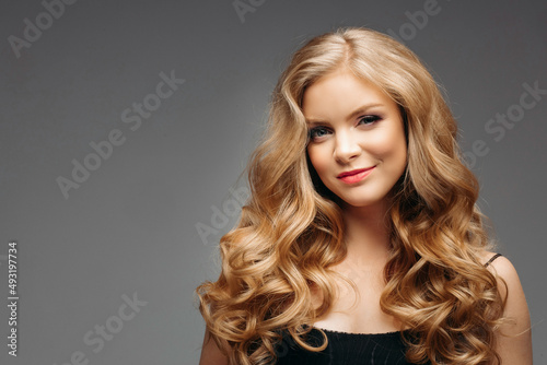 Surprised young woman smiling in studio smiling