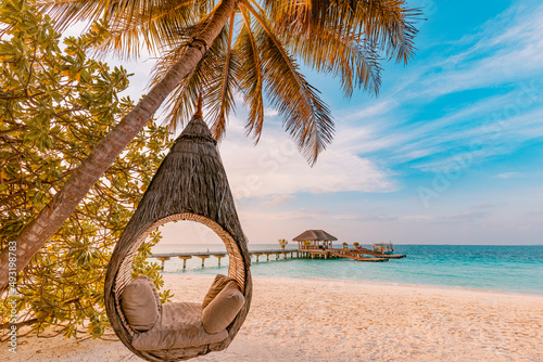 Fototapeta Naklejka Na Ścianę i Meble -  Tropical beach sunset as summer landscape with luxury resort beach palm swing hammock, sand seaside shore for sunset beach landscape. Tranquil beach horizon scenery vacation and summer holiday concept