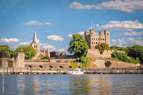 RView of historical Rochester across river Medway in sunny afternoon, England