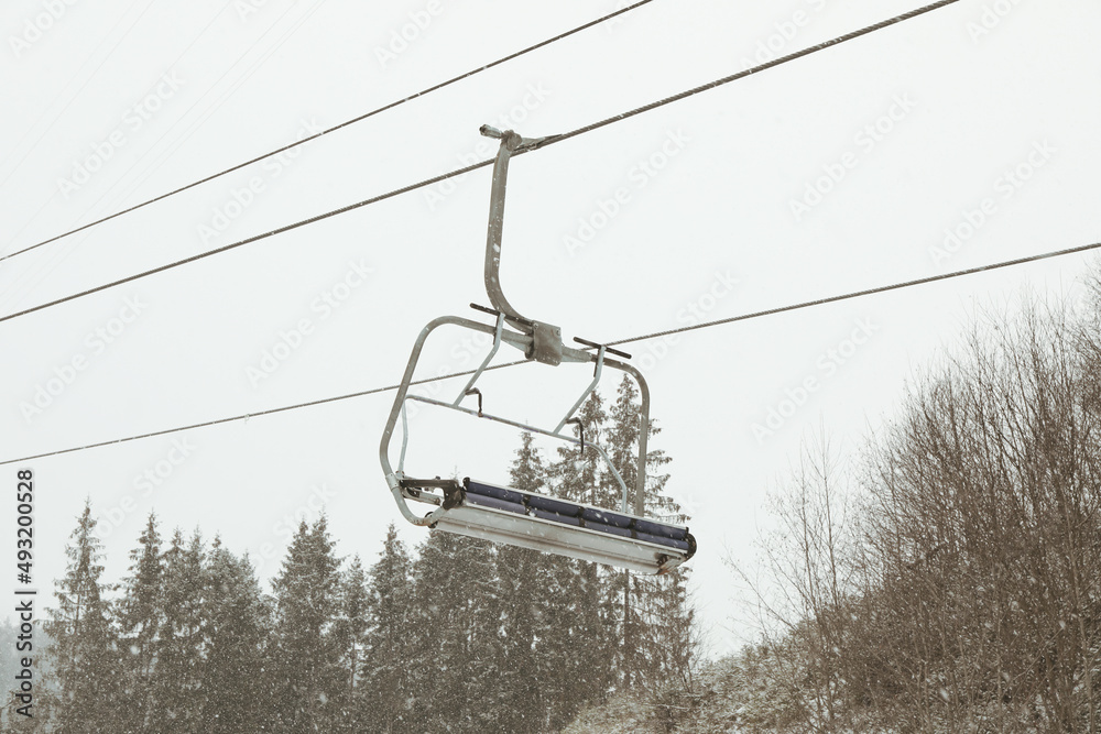 Empty ski lift in snowy day in Carpathians