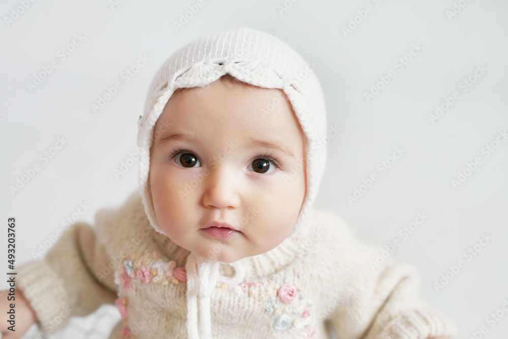 Cute baby girl in knitted clothes and hat with teddy bear toy. Children Protection Day. Mother's day greeting card. International day of happiness. Cute baby girl in knitted clothes and hat with teddy bear toy. Children Protection Day. Mother's day greeting card. International day of happiness.