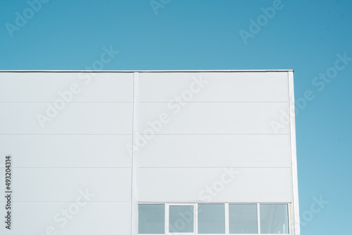 Corner of an industrial building, sandwich panel wall with windows exterior view photo